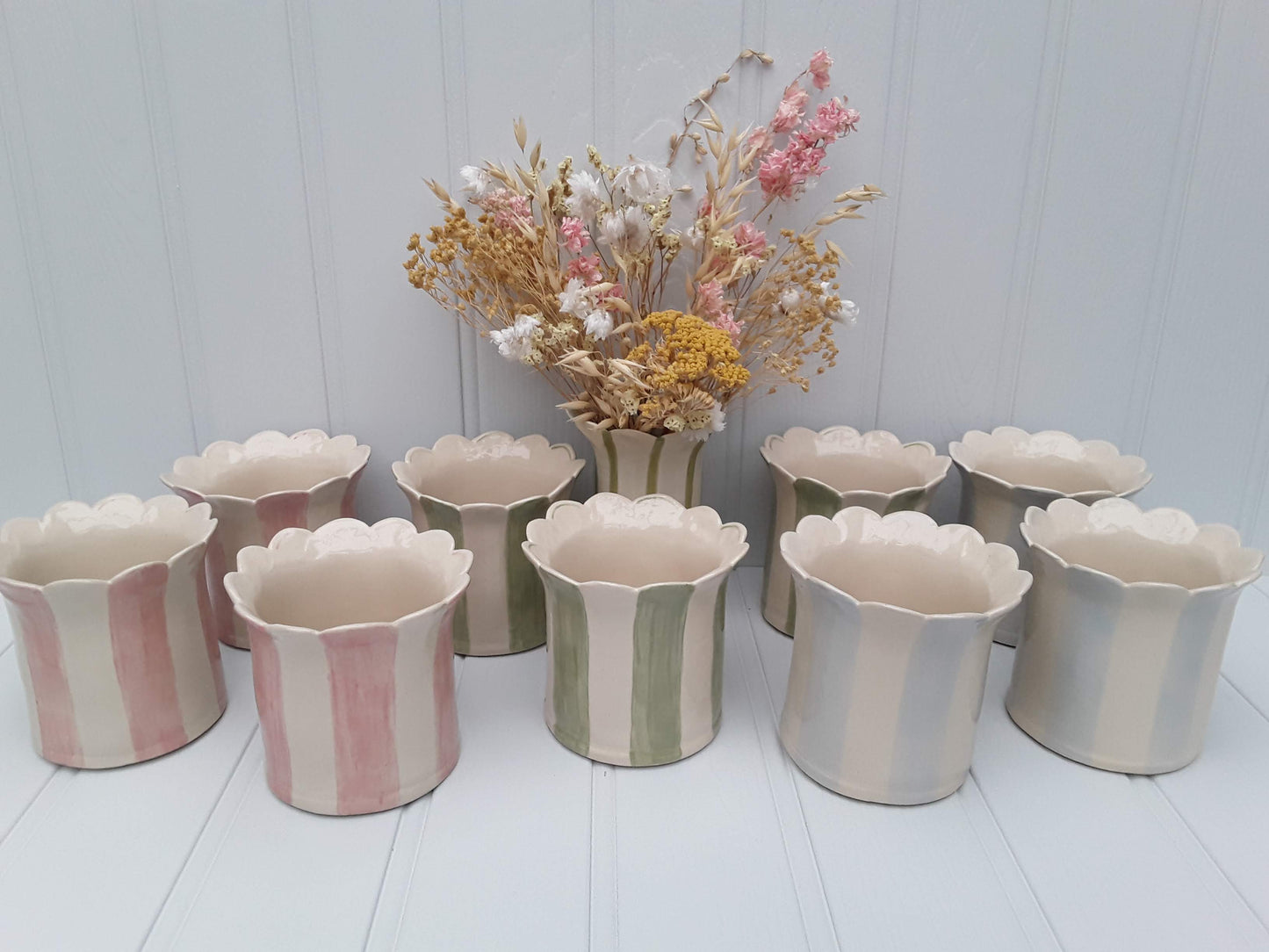 A collection of Pink, Sage and Baby blue planters by Sea Bramble Ceramics.