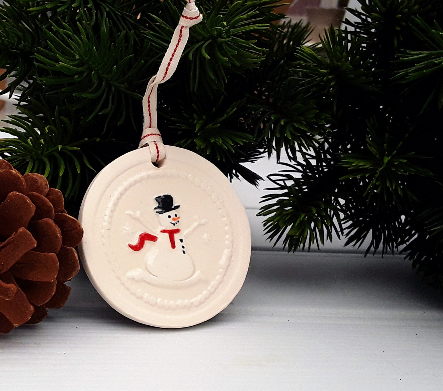 Circular ceramic Christmas tree decoration with snowman motif