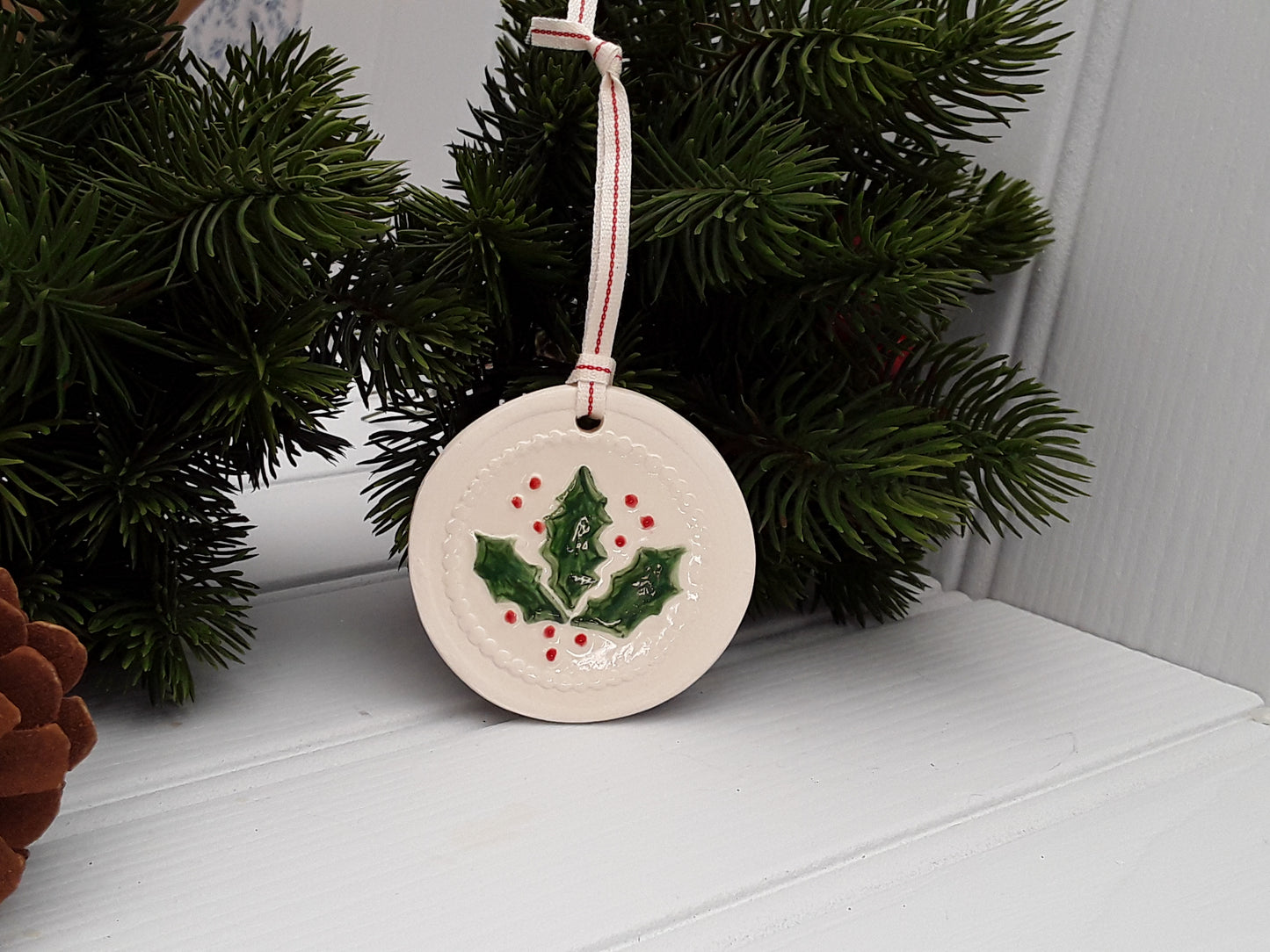 Circular Ceramic Christmas tree decoration with Holly motif