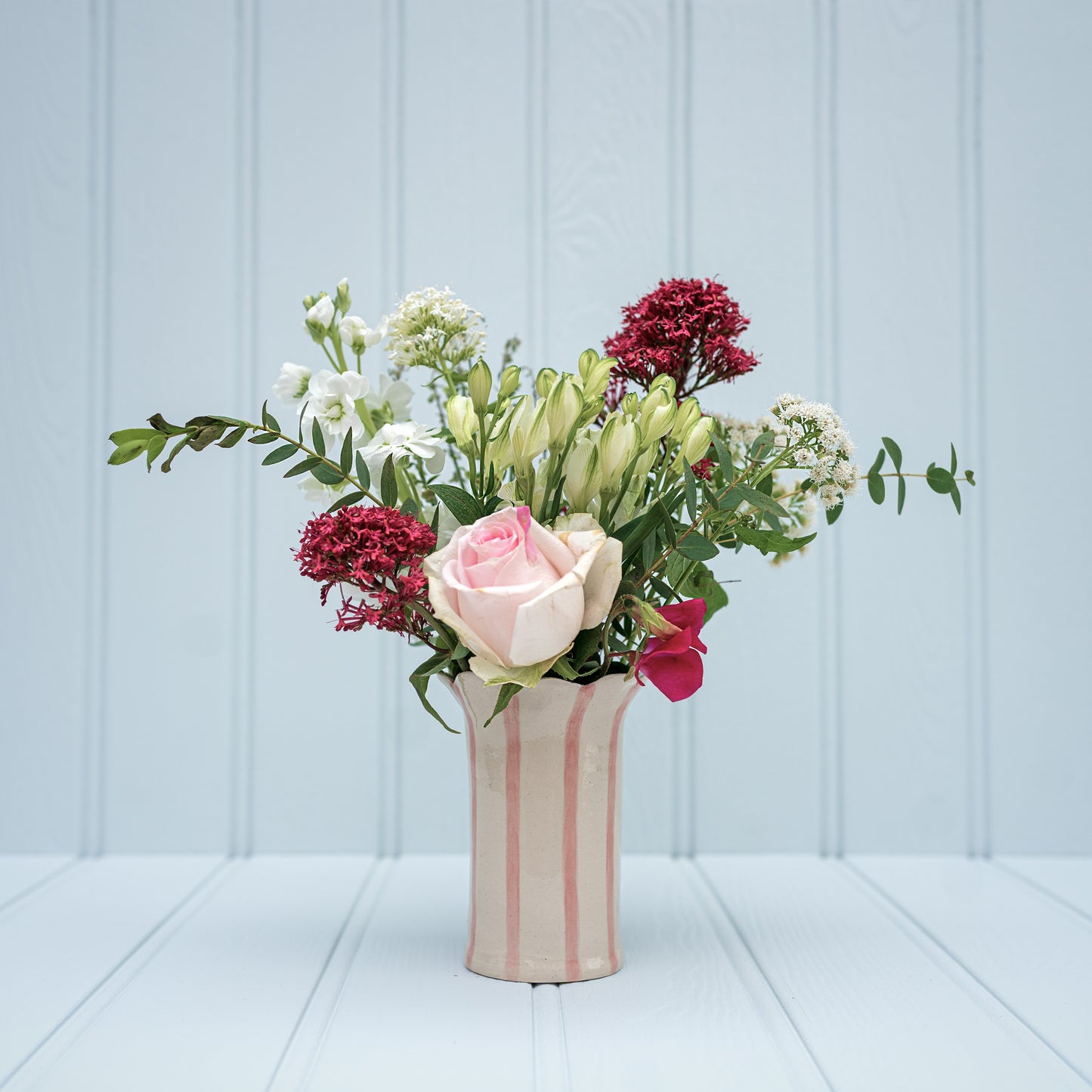 Sea Bramble Ceramics' Handmade, Daisy vase, pink stripes and Sea Brambles' signature scalloped top.