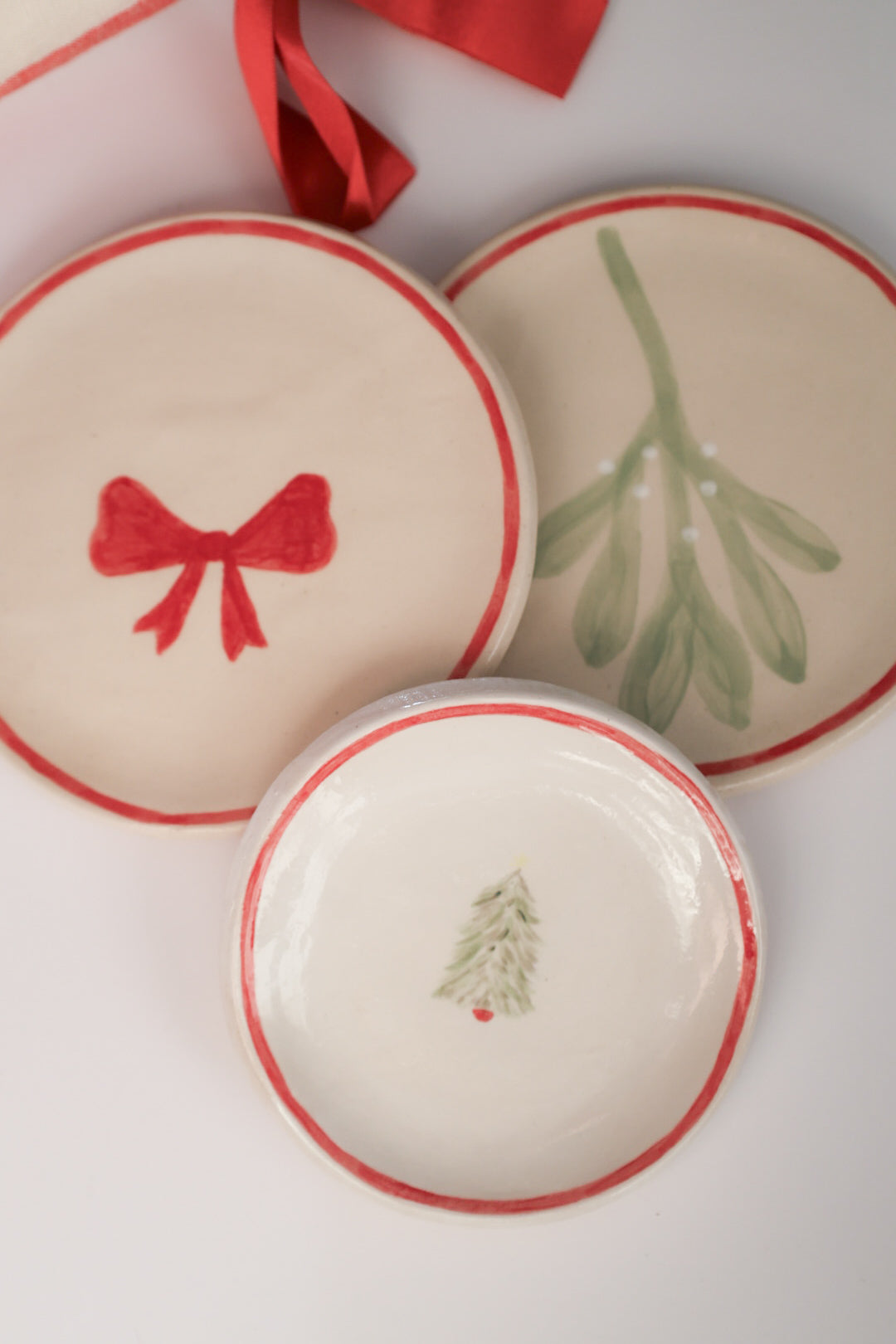 Three ceramic dishes with festive designs.  Christmas plates. Sea Bramble Ceramics. Decorative plates.