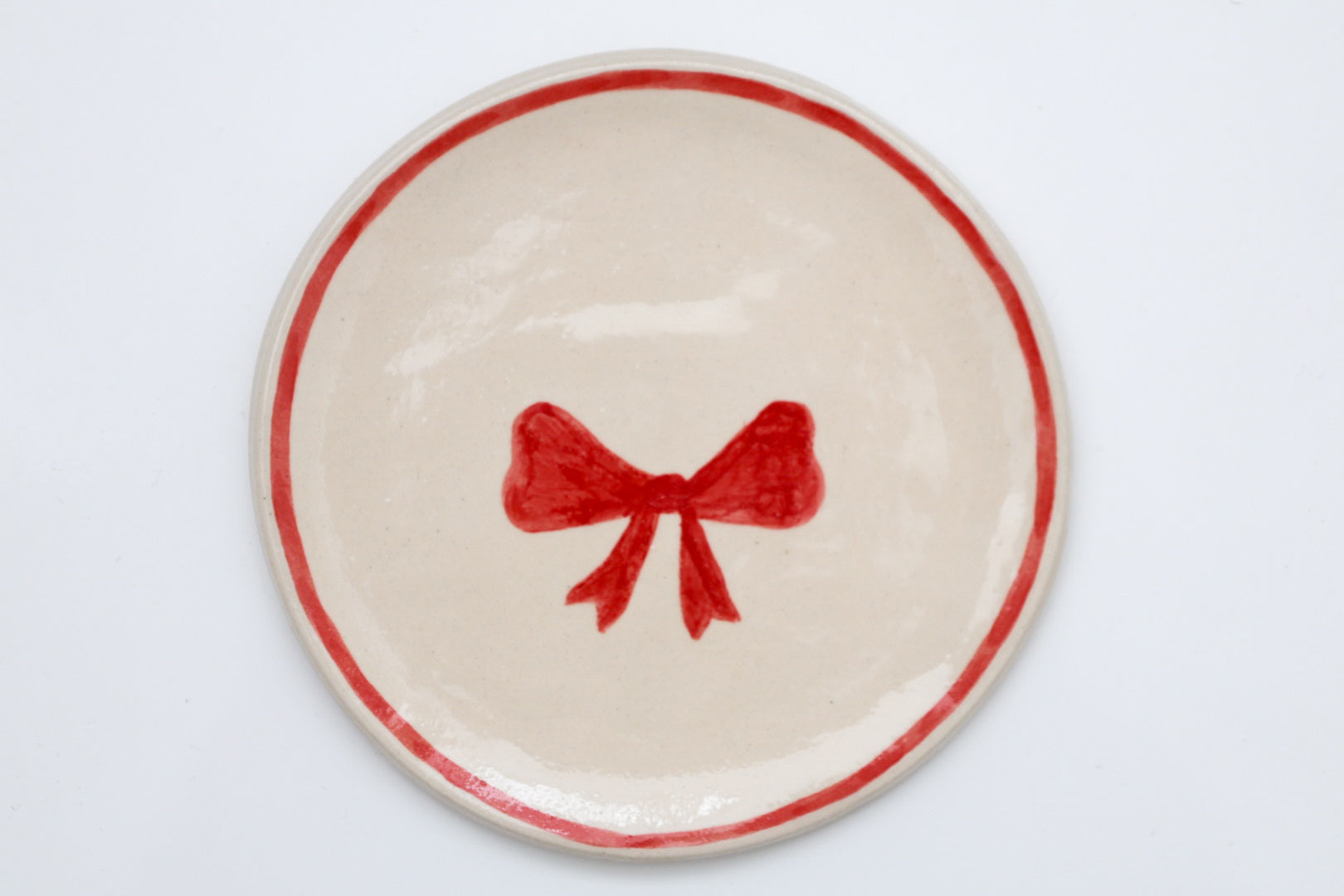 Ceramic stoneware plates with a Christmas bow design. Handmade, hand-painted. Sea Bramble Ceramics. Decorative plates.