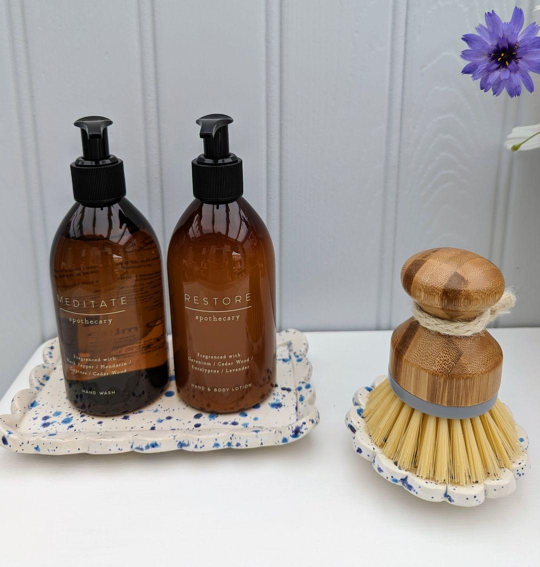 Speckled blue sink bottle stand with matching brush dish