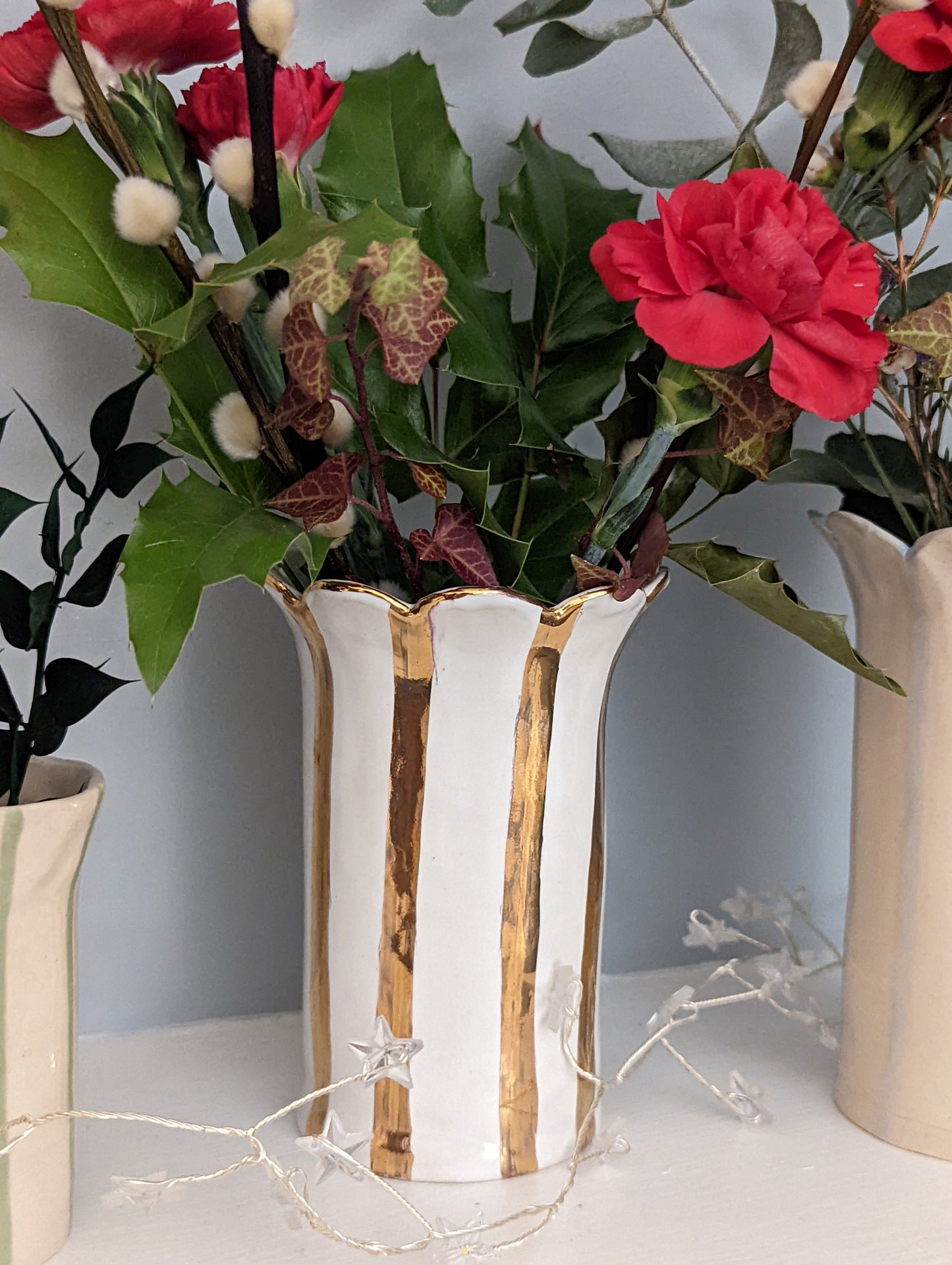 Sea Bramble ceramics - Handmade Stoneware Daisy vase with gold stripes and that Sea Bramble' signature scalloped top. This close-up photo is of the vase adorned with a beautiful flower arrangement.