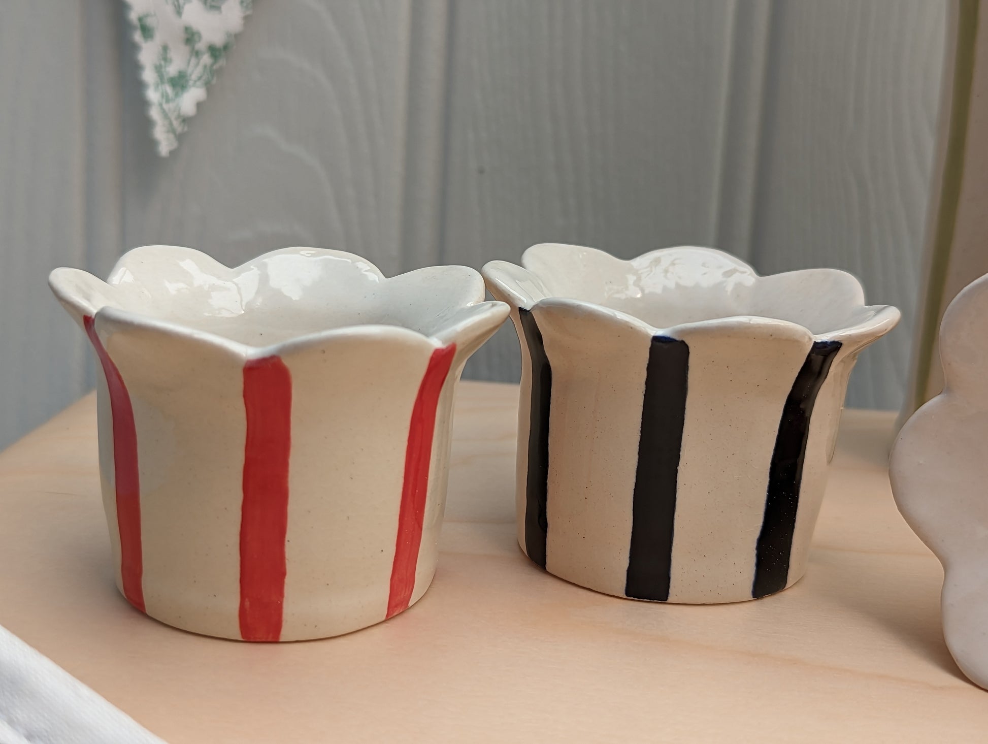 Sea Bramble Ceramics - Homemade Earthenware Striped and Scalloped tealight holders. Shown in close-up, Red & Navy blue.