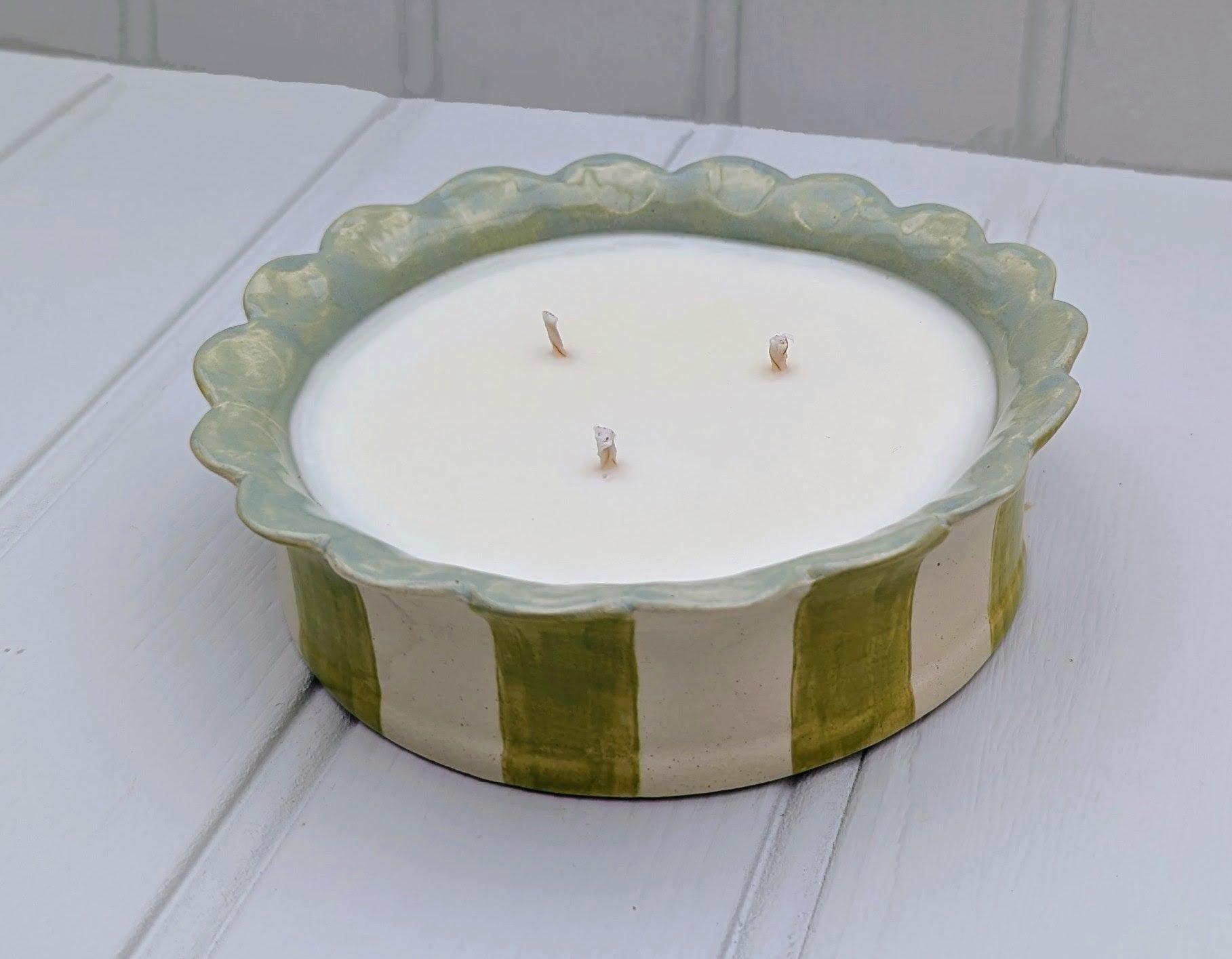 Sea Bramble Ceramics - Handmade, Earthenware 3 wick candle. In Pink, Sage, Baby blue stripes or White, all with Sea Brambles beautiful signature scalloped top. Shown in Sage and viewed from the front.